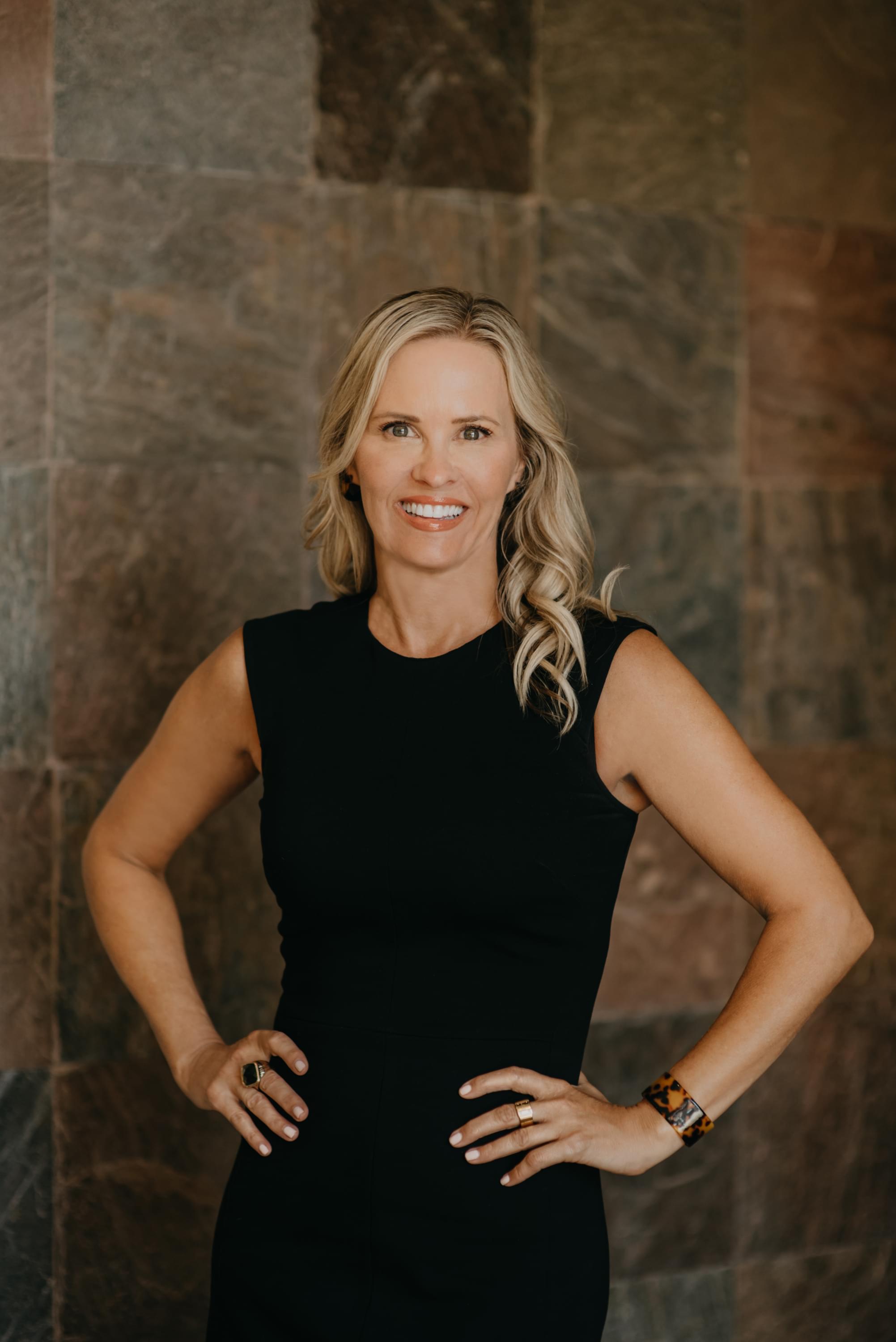 Photo of Kelly Smith with her book, Top 10 Profit Killers for Plastic Surgeons & Medical Spas